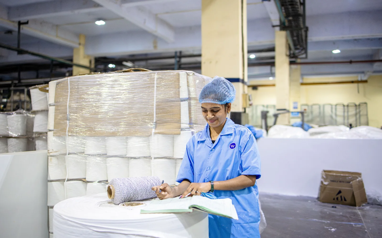 A manufacturing worker checking materials on the production floor